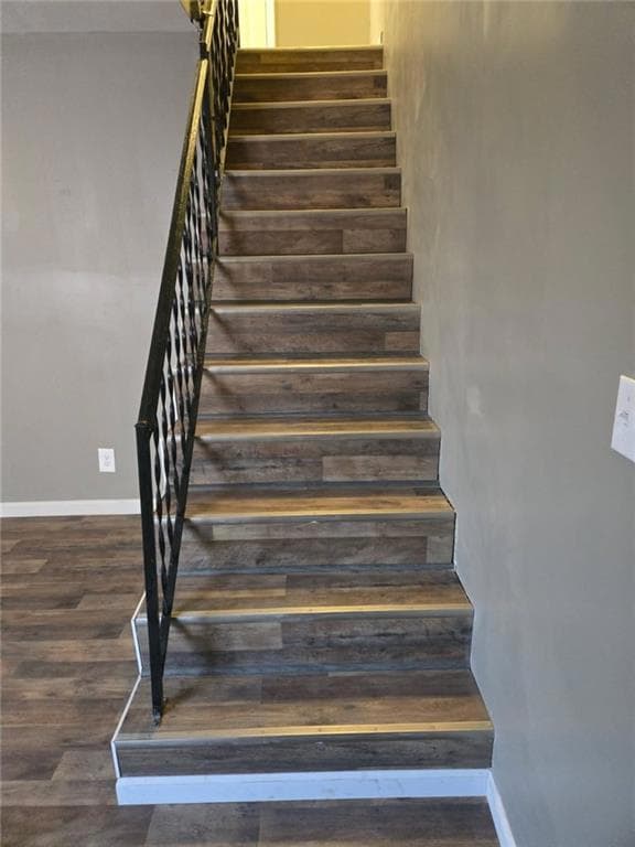 Stairs with baseboards and wood finished floors