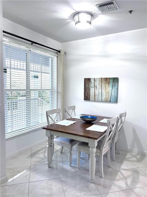 Dining room with light tile patterned floors