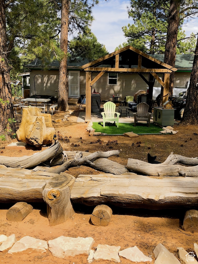 Back of house with a gazebo, a patio, and an outdoor living space