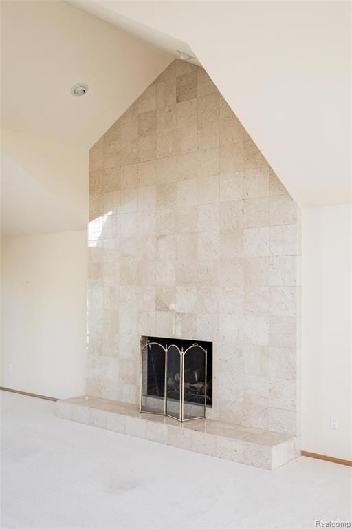 Detailed view of carpet and a tile fireplace