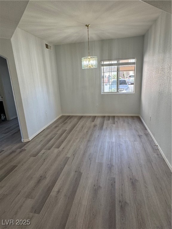 Unfurnished dining area with baseboards, wood fini