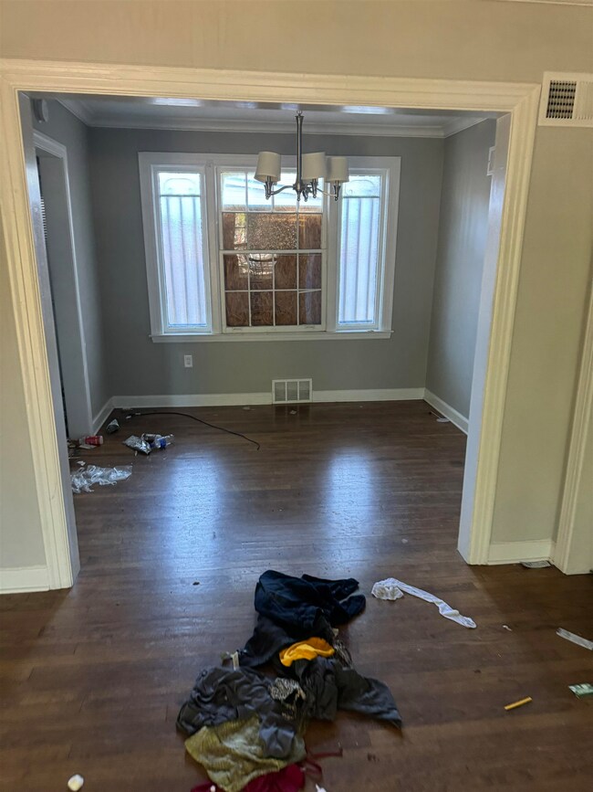 Unfurnished dining area with an inviting chandelie