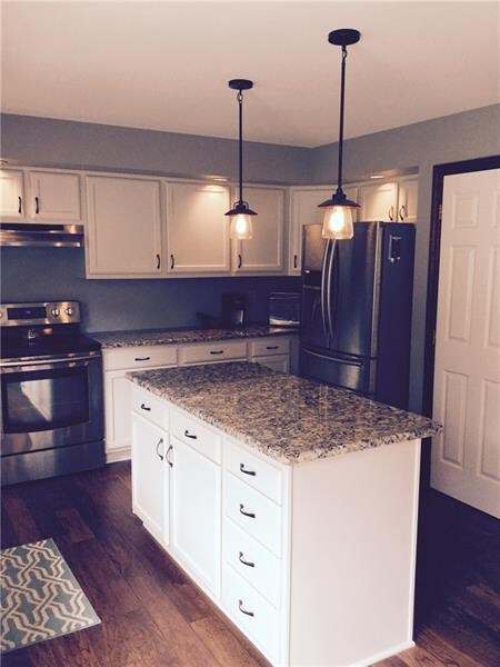 Large Granite Island with abundance of storage..notice the updated lighting as well.. this Kitchen is a dream...with a pantry as well!