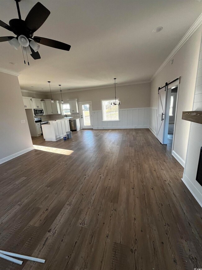 Unfurnished living room featuring crown molding, a
