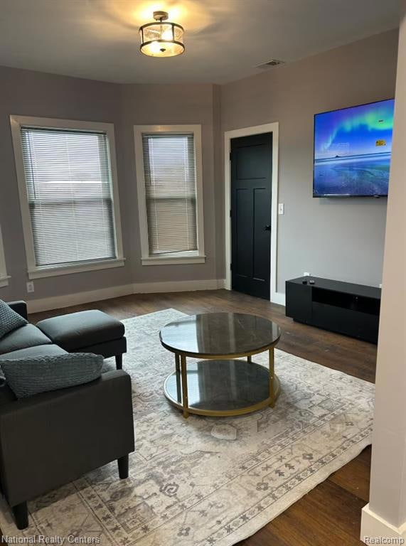 Living room with wood finished floors and baseboards