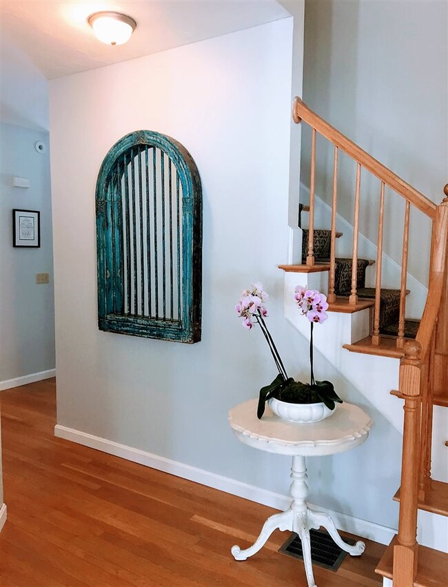 Attractive hardwood flooring, corner stairway lend
