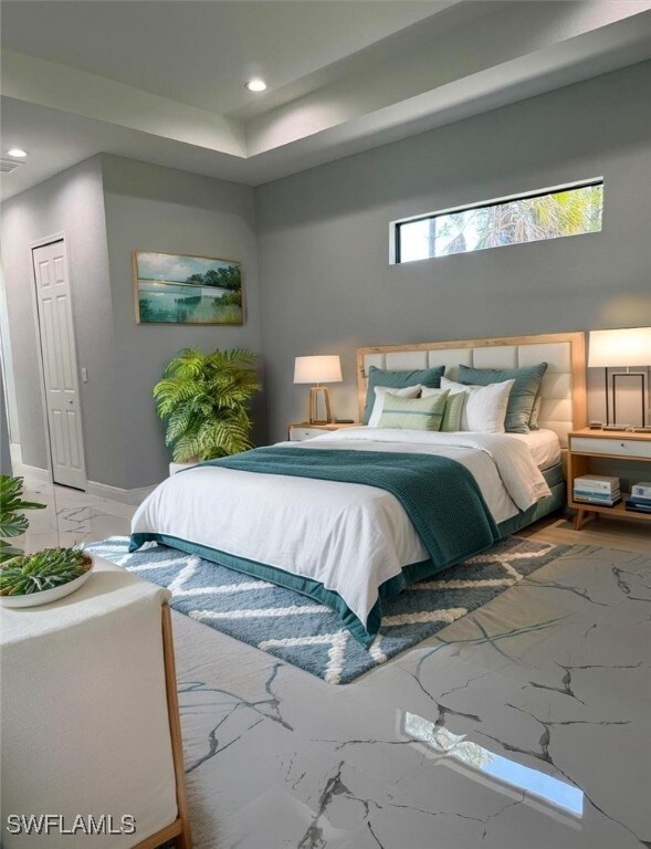 Bedroom featuring marble tiled floors, recessed li