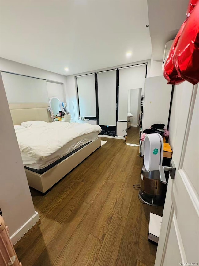 Bedroom featuring dark wood-type flooring and recessed lighting