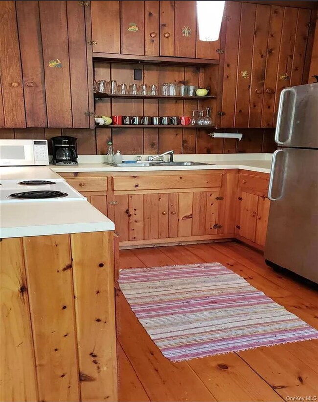 Kitchen is fully equipped and has open shelves, loads of storage and great workspace..