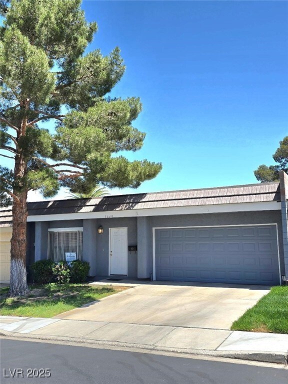 Single story home with stucco siding, an attached