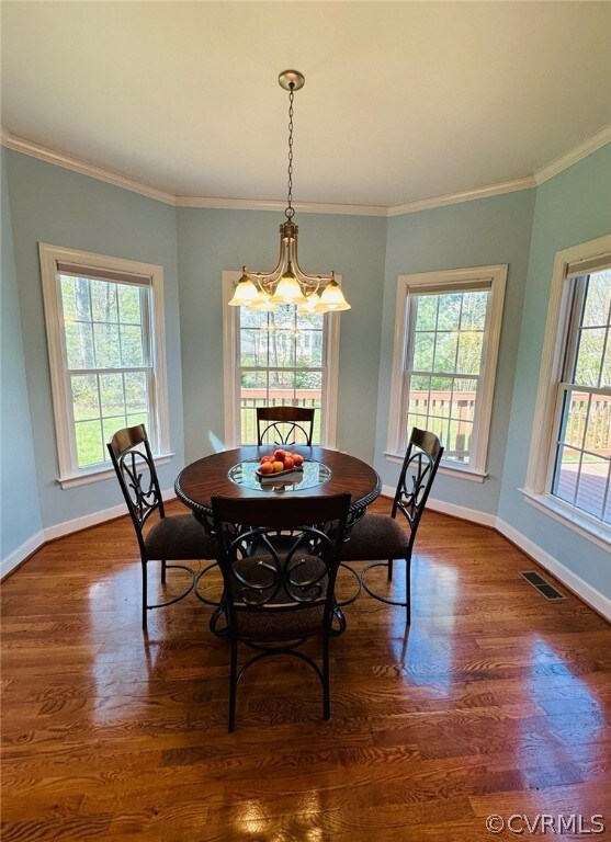 Dining area featuring a chandelier, ornamental mol