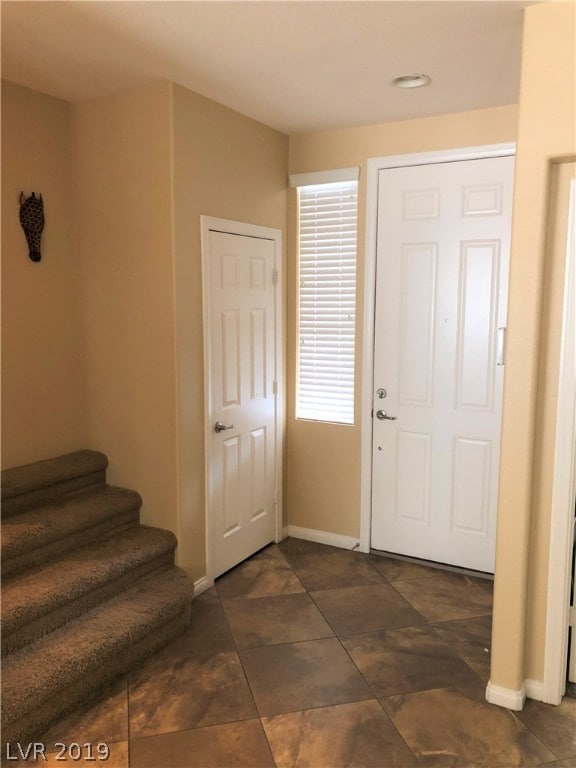 FRONT DOOR. STAIRS TO LEFT, DEN AND HALF BATHROOM