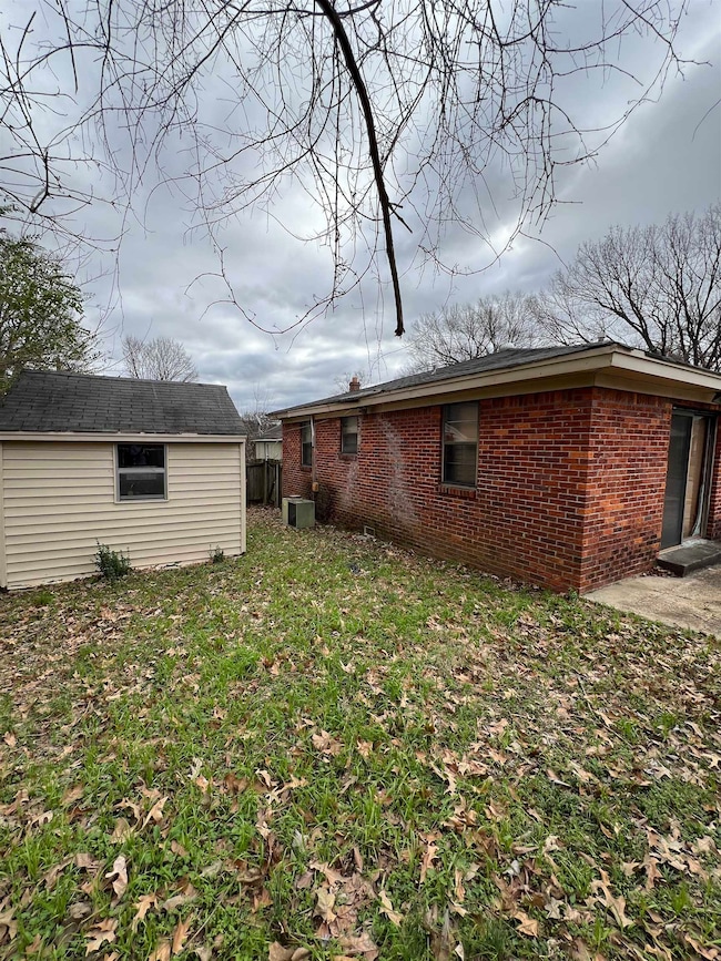 Exterior space featuring a yard, an outdoor struct