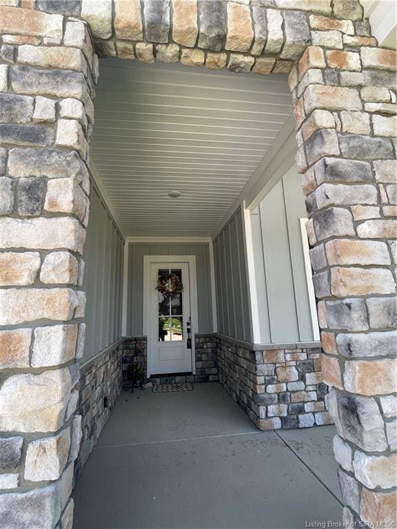 Inset front door convenient for package delivery out of sight & out of weather detailed with hardie & stone