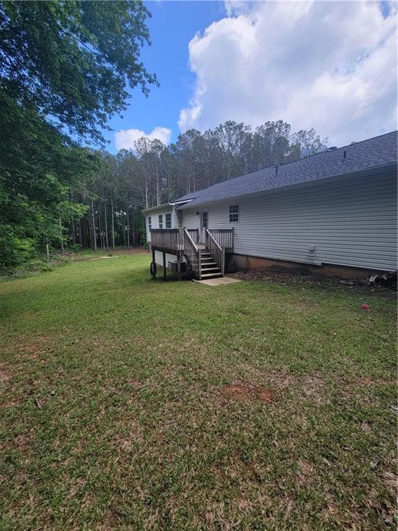 Back of property featuring a wooden deck, a shingl