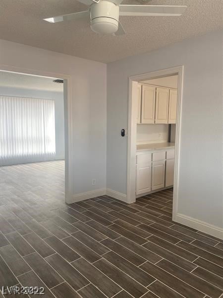 Spare room with wood finish floors, ceiling fan, a