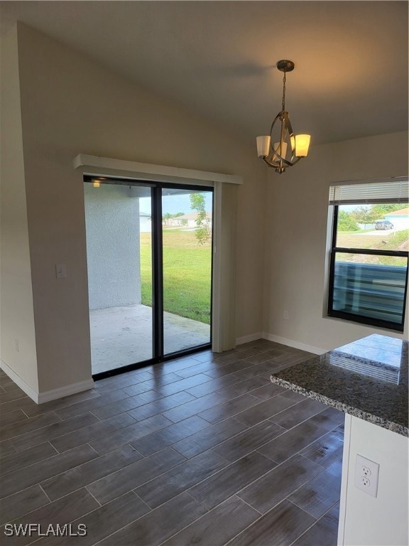 Unfurnished dining area featuring baseboards, a he