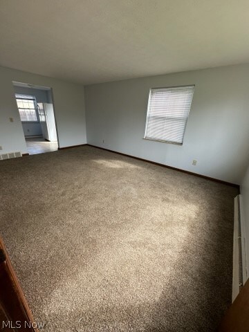 Unfurnished room featuring carpet flooring
