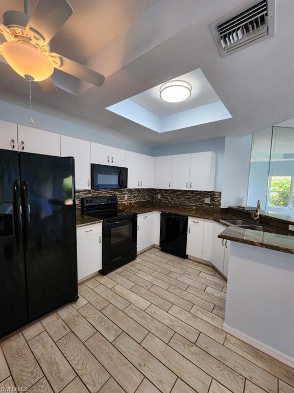 Kitchen featuring white cabinets, visible vents, a
