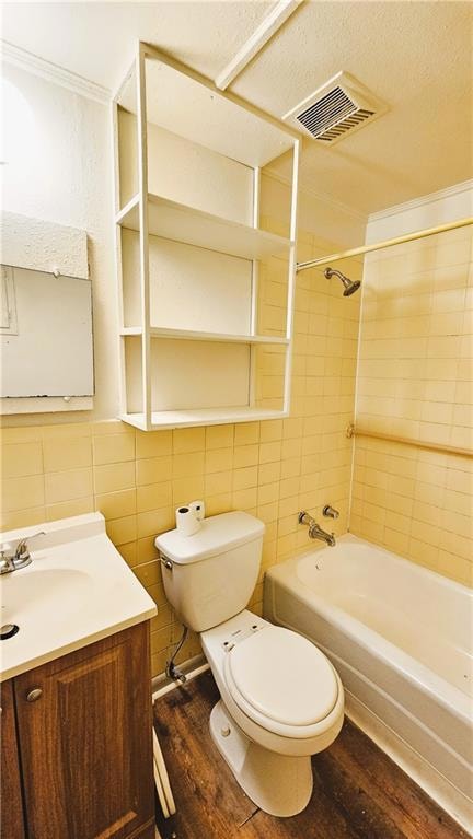 Full bathroom featuring visible vents, tile walls,