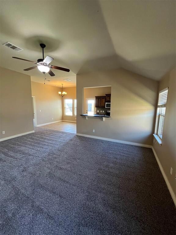Unfurnished living room featuring ceiling fan with