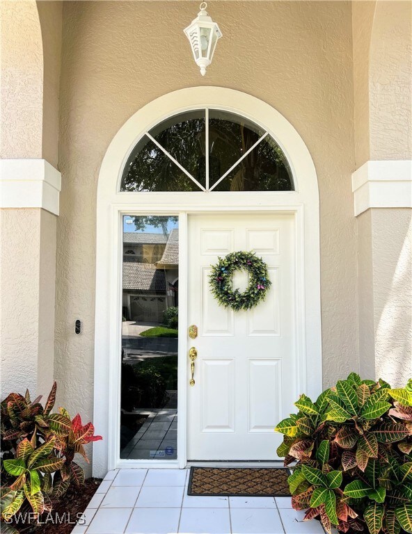 Property entrance with stucco siding