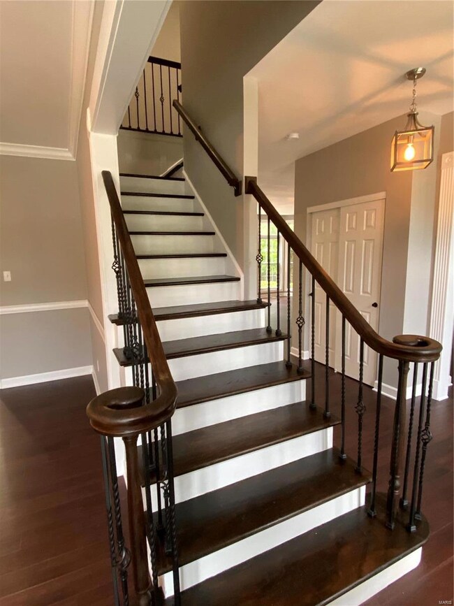 Hardwood staircase with new wrought iron balusters
