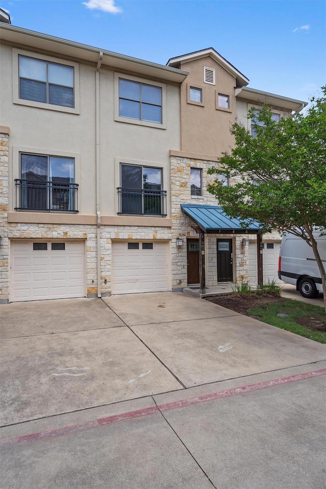 Townhome / multi-family property with stone sidin