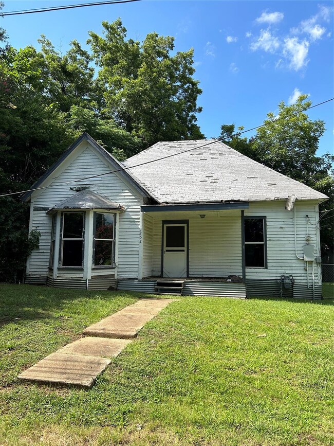 Bungalow-style home featuring a front lawn