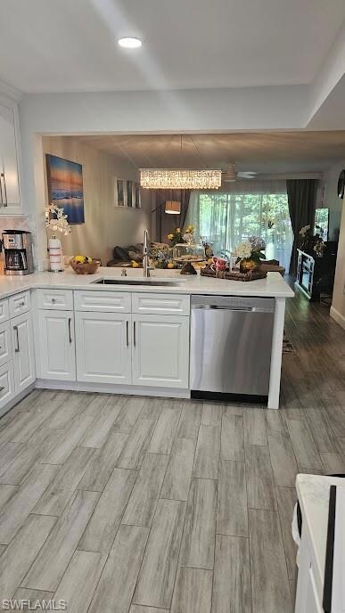 Kitchen with a sink, white cabinetry, dishwasher, 