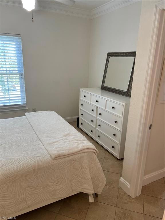 Tiled bedroom with baseboards and crown molding