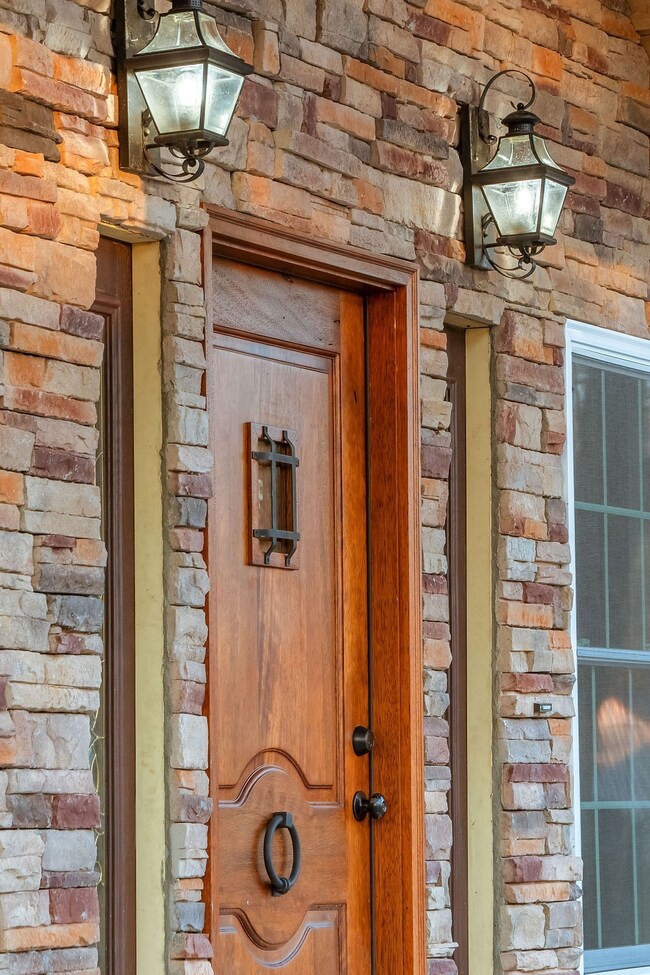 Inviting Old world entrance door with peak a boo door built in.