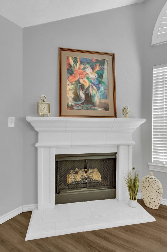 Cast Stone Fireplace with Gas Logs that come on with a flip of the switch.