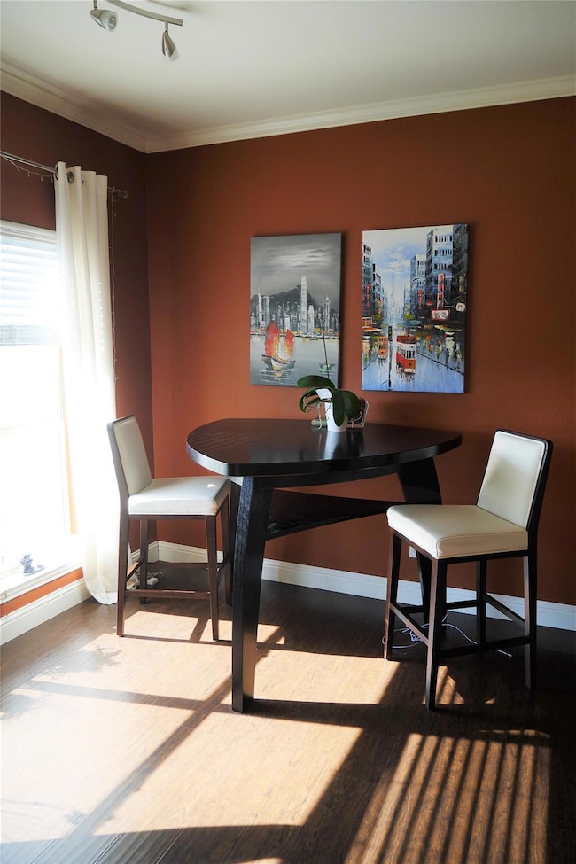 Dining room featuring baseboards, wood finished f