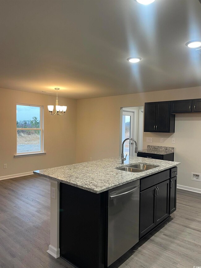 Kitchen featuring stainless steel dishwasher, sink