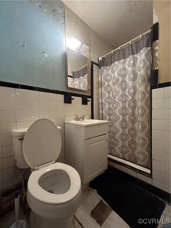 Bathroom featuring tile walls, toilet, vanity, a s