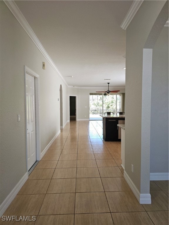 Hallway with light tile patterned floors and crown