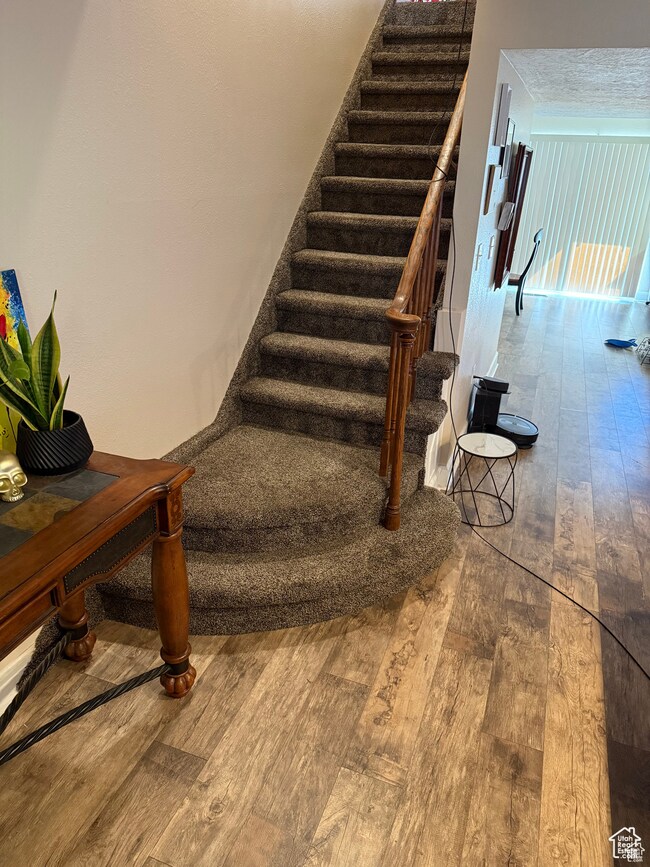 Stairway with hardwood / wood-style floors