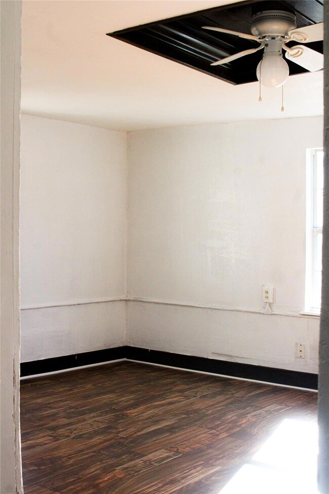 Empty room featuring ceiling fan and wood finished
