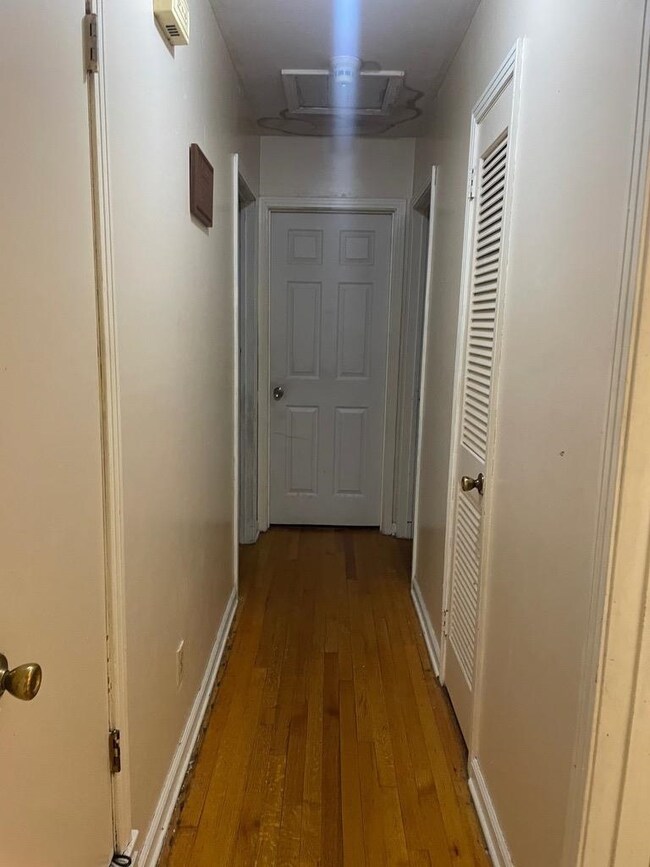Corridor with light wood-type flooring