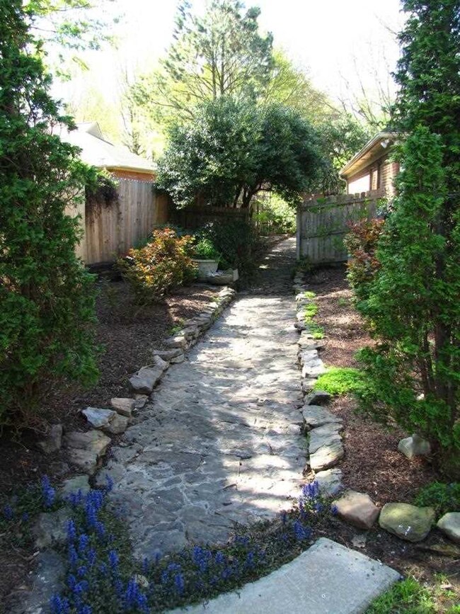 A custom stone walking path leads you to the backy