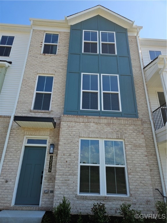 View of property featuring brick siding