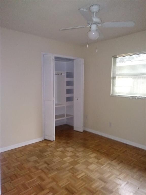 Bedroom with custom shelving in closets.