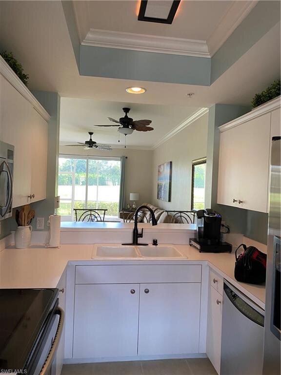 Kitchen with white cabinetry, dishwashing machine,