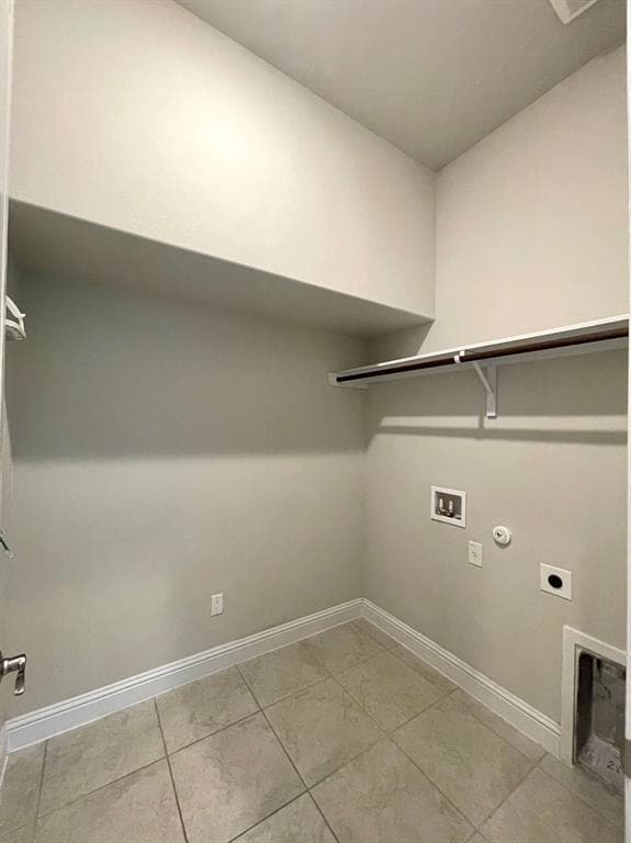 Laundry room featuring gas dryer hookup, hookup for an electric dryer, hookup for a washing machine, and light tile patterned flooring