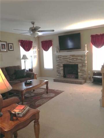 Open Family Room with Custom Brick Fireplace. The Mantel is prewired for your Big Screen TV with attachments for media boxes on the right side.