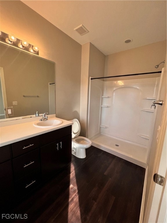 Full bath featuring wood finished floors, vanity,