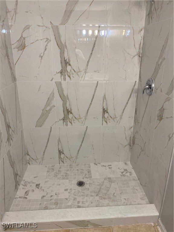 Full bath with a tile shower
