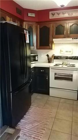 Kitchen with ceramic tile floor and solid surface 