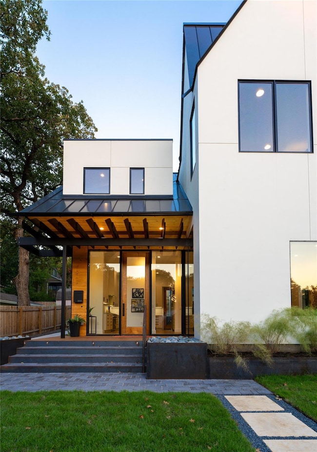 Rear view of house featuring a standing seam roof
